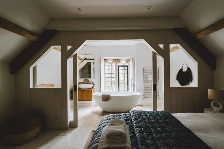 A bedroom with a freestanding bath